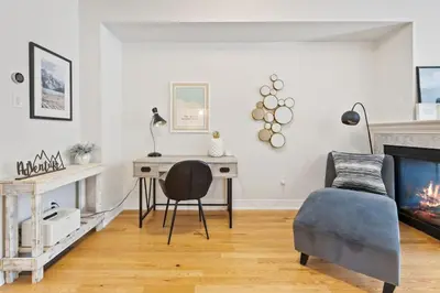 a living room with a desk and a chair at Mountain View Townhouse Fresh and Bright at Blue in Collingwood
