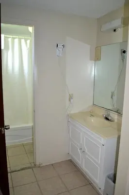 a bathroom with a sink and a mirror at Lighthouse Motel in Walkerton
