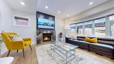 a living room with a couch and a fireplace at Family Modern walkout Basement wSauna Indoor Fireplace Wifi in Innisfil