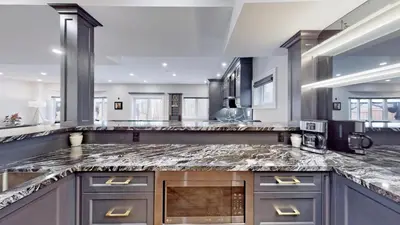 a large kitchen with a marble counter top at Family Modern walkout Basement wSauna Indoor Fireplace Wifi in Innisfil