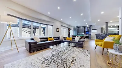 a living room with a couch and a table at Family Modern walkout Basement wSauna Indoor Fireplace Wifi in Innisfil
