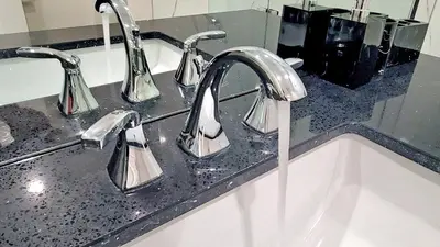 a bathroom sink with two chrome faucets on it at Family Modern walkout Basement wSauna Indoor Fireplace Wifi in Innisfil
