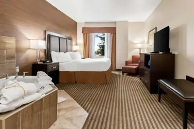 a hotel room with a bed and a bath tub at Best Western Plus Fergus Hotel in Fergus