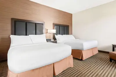 a hotel room with two beds and a desk at Best Western Plus Fergus Hotel in Fergus
