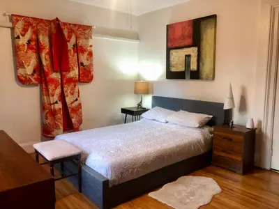 a bedroom with a bed and a dresser and a window at Beautiful house in central Toronto with backyard in Toronto
