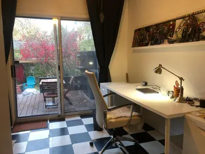 an office with a desk and a table and a window at Beautiful house in central Toronto with backyard in Toronto