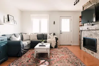 a living room with a couch and a fireplace at Fox Lane - Prince Edward County Farmhouse in Picton