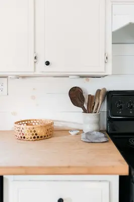 a kitchen counter with a wooden counter top with utensils at Hart House a fresh 3 bedroom century home in Cherry Valley