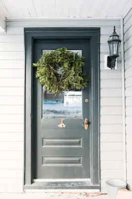 a green door with a christmas wreath on it at Hart House a fresh 3 bedroom century home in Cherry Valley