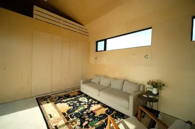 a living room with a couch and a rug at Hygge House Cozy Boutique Guest House in Hillier