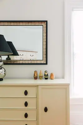 a dresser in a living room with a mirror at Watson House - Century Home near Sandbanks in Cherry Valley