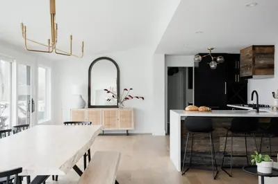 a kitchen with a table and a dining room at Wellers Landing - Prince Edward County Lakehouse in Carrying Place