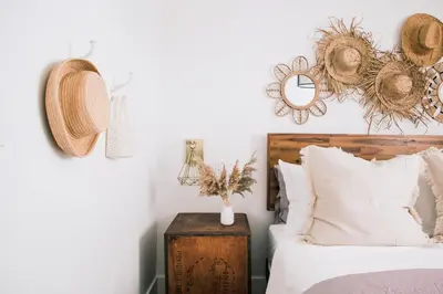 a bedroom with a bed and hats on the wall at Wellers Landing - Prince Edward County Lakehouse in Carrying Place