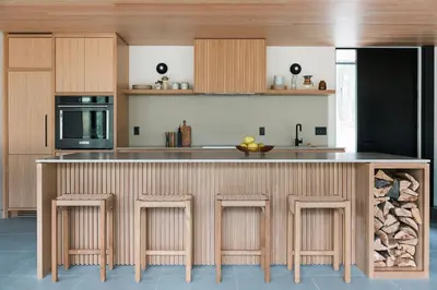 a kitchen with a large counter with bar stools at nortehaus - Nordic and Japanese inspired escape in Norland