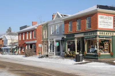 a street with shops and buildings on a snowy street at Greaves Sweet Escape in Niagara on the Lake