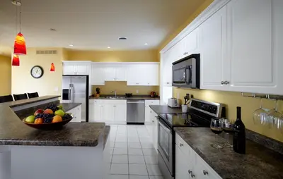 a large kitchen with a bowl of fruit on the counter at Greaves Sweet Escape in Niagara on the Lake