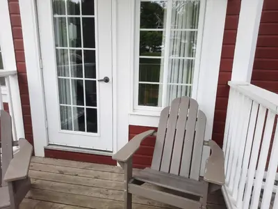 two chairs sitting on the porch of a house at Margarita Vacation Getaway in Oro-Medonte