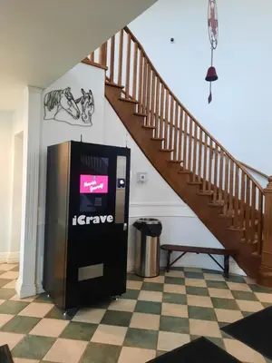 a ticket machine in a room with a staircase at Margarita Vacation Getaway in Oro-Medonte