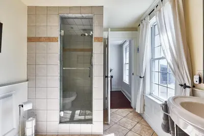 a bathroom with a shower and a sink at Bramasole Bed and Breakfast in Roseneath