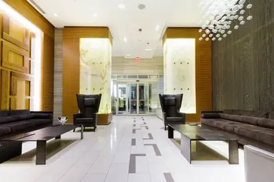 a lobby with couches and tables in a building at Luxury King Bed Condo with Stunning City Views in Toronto