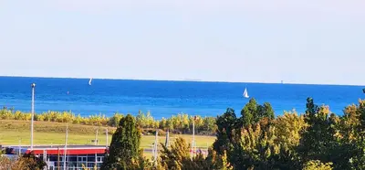 a view of the ocean with a building and a boat at Lakeview Condo in Downtown with Free Parking. in Toronto