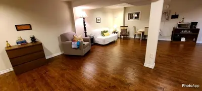 a living room with a hard wood floor at Spacious and bright unit with natural light. in Pickering