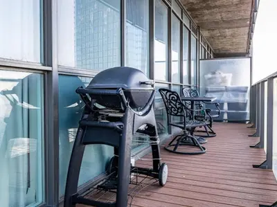 a hallway with chairs and a stroller in a building at Pristine Modern 2BR Condo Private BBQ and Balcony in Toronto