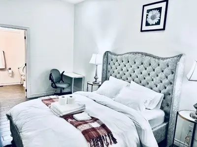 a bedroom with a large bed with a gray headboard at Lavida Luxury Room #1 in London in London