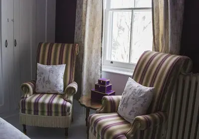 a living room with two chairs and a window at Lakehurst Estate in Cobourg