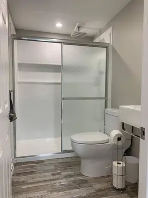 a bathroom with a toilet and a glass shower at ENTIRE 1 BEDROOM APARTMENT DOWNTOWN - u4 in Waterloo