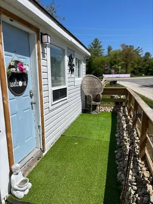 a front door of a house with green grass at Casa Di Nonna in Wasaga Beach