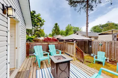 a deck with blue chairs and a table at Mary Jane's Cottage in Crystal Beach