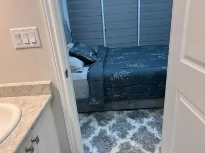 a bathroom with a bed and a sink at New Kleinburg Towns in Woodbridge