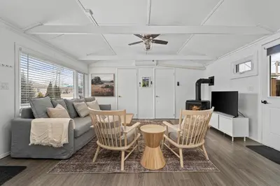 a living room with a couch and a table and chairs at The Birch in Wellington