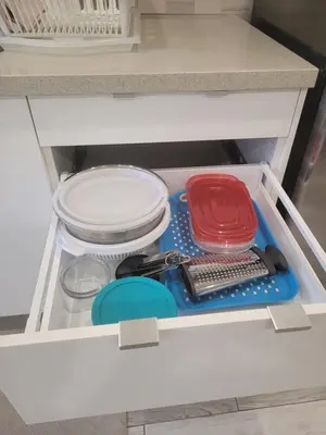 a drawer in a kitchen with dishes and utensils at Modern studio with kitchenette and bath in Guelph