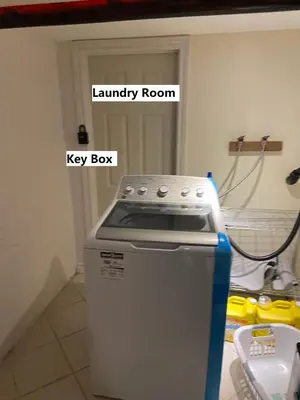 a kitchen with a key box and a laundry room at BASEMEWNT Room with private bathroom 36C in Toronto
