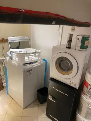 a washing machine and a washer and dryer in a room at BASEMEWNT Room with private bathroom 36C in Toronto