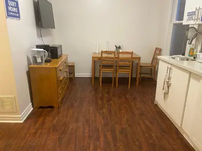 a room with a kitchen with a table and a dining room at BUDGET Triple Room with En Suite Bathroom 36A in Toronto