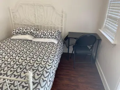 a bedroom with a bed and a desk and a chair at BUDGET Quad Room with En Suite Bathroom 36B in Toronto