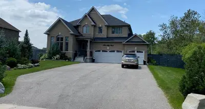 a truck parked in front of a house at Gilford Beach Apartment in Innisfil