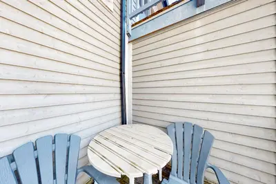 two blue chairs and a wooden table in a room at Condo 612 at North Creek Resort in Blue Mountains