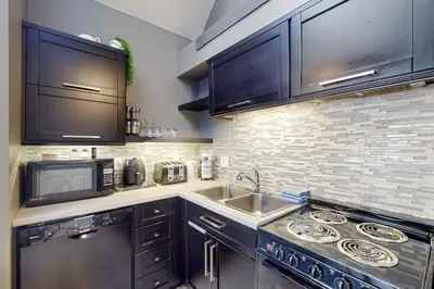 a kitchen with a sink and a microwave at Condo 612 at North Creek Resort in Blue Mountains