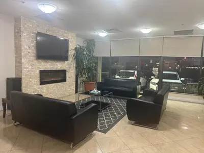 a living room with couches and chairs and a fireplace at NU Hotel Toronto Airport in Mississauga