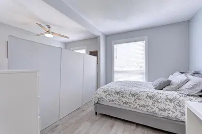 a white bedroom with a bed and a window at Niagara Falls-Toronto-45 Min Drive- 26 OOOO75-Max 8 in Hamilton
