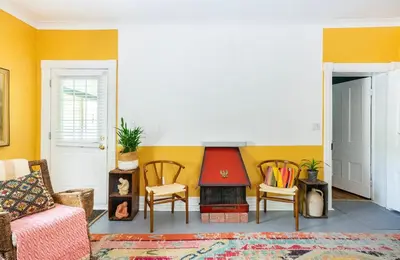 a living room with a couch and a fire place at The River Farmhouse in Corbyville