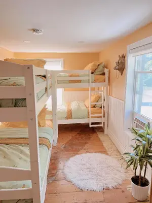 a room with four bunk beds and a window at The River Farmhouse in Corbyville