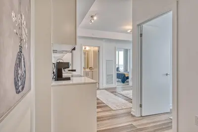 a kitchen with white walls and a counter top at 2 Bedroom, 2 Bath Stunning Condo - heart of Kitchener Downtown in Kitchener