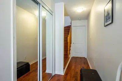 a hallway with a sliding glass door and a stairway at Beautiful Townhouse In Toronto in Toronto