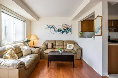 a living room with a couch and a table at Beautiful Townhouse In Toronto in Toronto