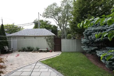 a backyard with a fence and a yard with a patio at Phoebe Wang in Toronto
